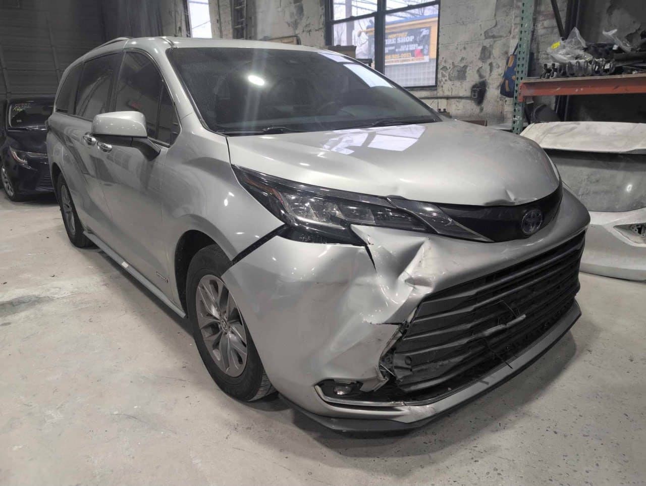 Toyota Sienna with front-end collision damage in the Linden shop