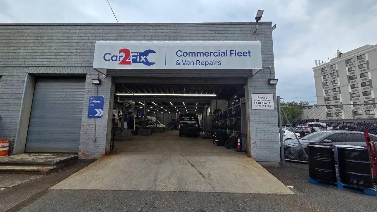 The Car2Fix shop at 408 Carnegie Ave, Newark, with the sign Commercial Fleet and Van Repairs and a Shuttle Group van inside the open bay door